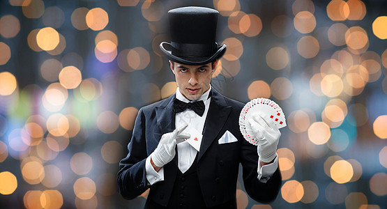 魔术,表演,赌场,人表演魔术师顶帽魔术与扑克牌近光灯背景背景图片