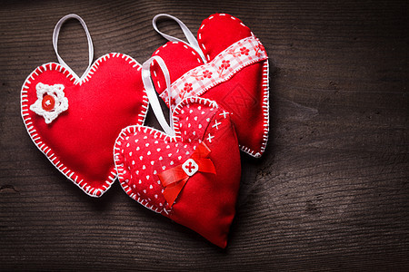 木制背景上缝制手工制作的红心手工制作的红心图片