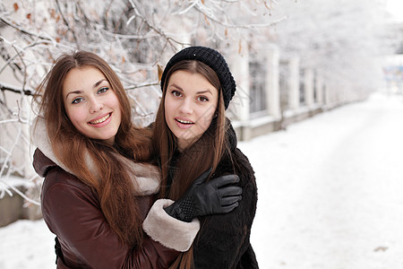 冬天两个可爱的轻女孩背景图片