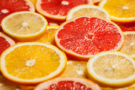 彩色柑橘类水果柠檬,橘子,柚子片背景图片