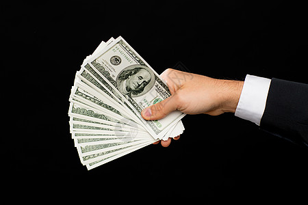 财务,人,储蓄财富密切的男手中持美元现金的黑色背景图片