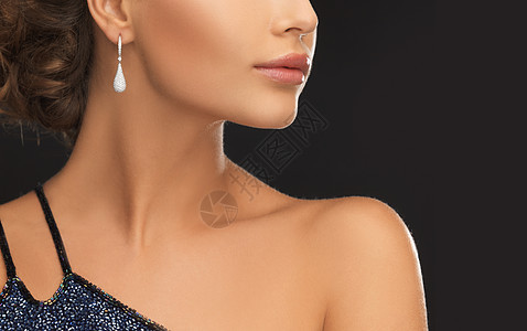 穿着晚礼服的漂亮女人戴着钻石耳环图片