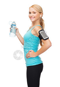 运动,锻炼,技术,互联网医疗保健运动的女人听音乐智能手机与水瓶图片