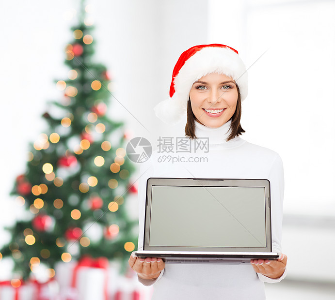 戴着圣诞帽的女人拿着笔记本电脑图片