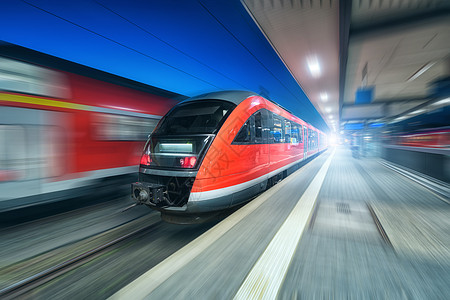 高速列车火车站夜间运行铁路站台上的现代城际列车工业乘客通勤红色列车运动模糊效应铁路铁路旅行高速列车图片