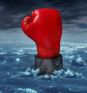 个戴着红色拳击手套的商人的手淹没了竞争商业,他站来挣扎着汹涌的海水中生存,以此比喻危机失金融世界竞争的战斗图片