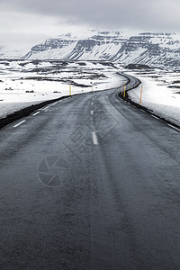 道路散落出冰岛冬季景观雪山图片