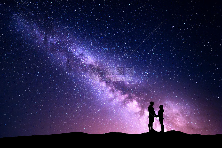 银河里人的轮廓风景与夜空与星星站立的男人女人牵手山上拥抱情侣抗