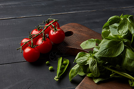 新鲜同的生蔬菜香料黑暗的木制背景上健康的机食品黑色木制背景上的新鲜蔬菜草药图片