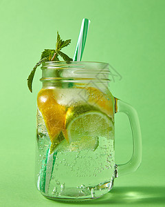 夏季天然泡新鲜柠檬水梅森璃罐与大气泡的空气绿色背景冷饮非酒精夏季饮料的清爽的碳酸自制饮料与天然成分柑橘类水图片
