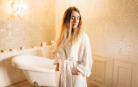 女生穿浴袍站在卫生间背景图片