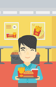 一位亚裔年轻人在咖啡馆背景上拿着满盘垃圾食品在快餐厅里笑的男人在快餐厅吃午矢量平面设计图垂直布局图片