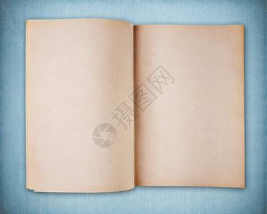 蓝色旧纸上的空白书笔记本背景图片