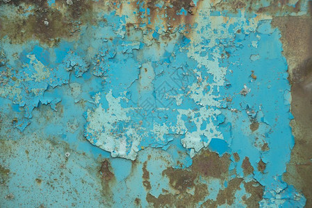 多彩背景旧生锈金属表面含蓝色涂料粉片和碎裂纹理图片
