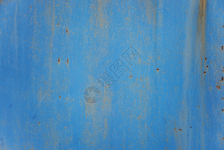 蓝色抽象背景生锈金属表面含蓝色涂料粉片和裂缝纹理图片