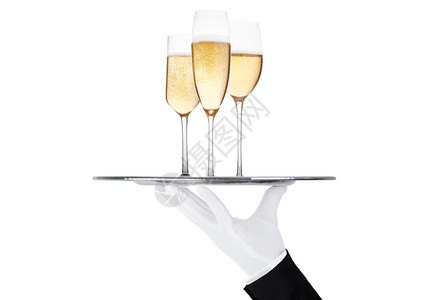 香檳装着黄色香槟杯子的托盘白色背景的泡和反光背景