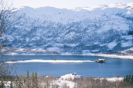美丽的景观传统挪威木屋站在湖边和远处的山上水高清图片素材