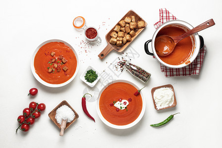 美味的红奶油汤配西柿辣椒和烤面包在家庭晚餐桌前平铺的素食白桌上的番茄汤图片