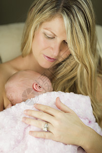婴儿依偎在妈妈的怀抱里图片