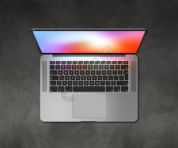 在混凝土桌上用彩色屏幕打开笔记本电脑顶部视图在混凝土桌上用彩色屏幕打开笔记本电脑顶部视图图片