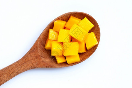 热带水果芒片白底木勺上的芒果片图片
