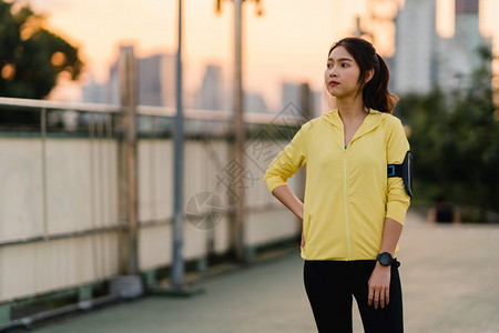 清晨在步行桥上穿运动服的日本少女城市的生活方式积极运动图片