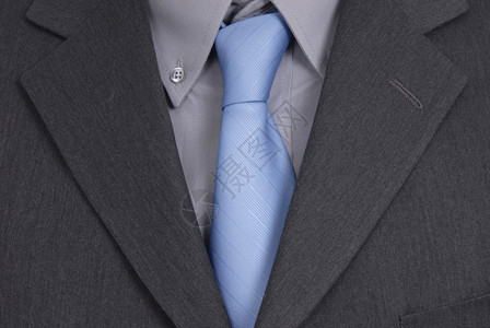 蓝色领带的商人西装细节图片