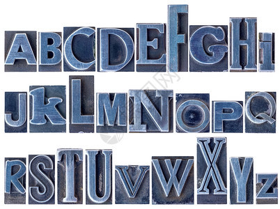 英文字母表纸印金属类刷块中26个孤立字母的拼图各种混合字体用蓝色墨水染图片