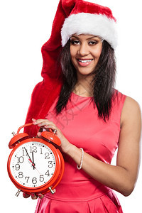 戴着闹钟的曼塔帽混血种族女子拿着闹钟的圣塔克拉斯帽快乐可爱女人混杂种族的非洲女孩被孤立圣诞节季图片