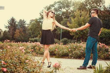 快乐的女孩手握在公园爱浪漫关系约会概念年轻女孩和男散步图片