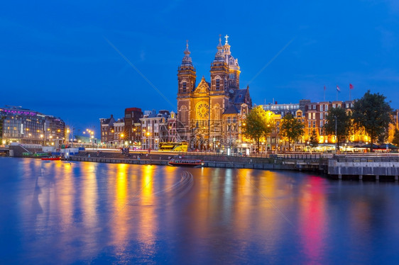 荷兰圣尼古拉斯的阿姆特丹运河桥和巴西利卡的夜景全城市象    荷兰圣尼古拉斯教堂和阿姆斯特丹运河夜景图片