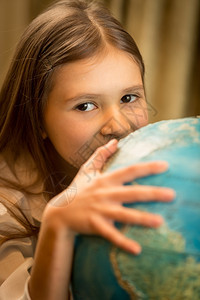 可爱女孩握着手抓地球的近视肖像图片