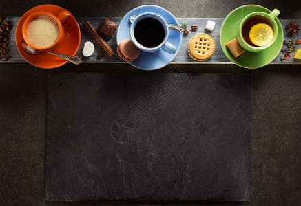 木板背景的橘绿蓝茶杯背景图片
