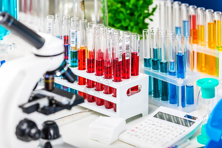 创意抽象化学发展医药生物学化和研究技术概念带有科学化实验室设备的表格显微镜带有色液体物质样本的测试管瓶报告文件等有选择焦点效果图片