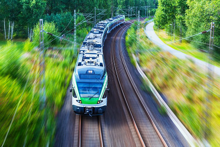 铁路和旅行游运输工业概念现代高速客运交通列车在轨道上行驶运动模糊效果优美的夏季景色图片