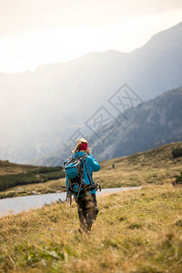职业运动穿服的妇女正在山上徒步旅行奥地利背景图片