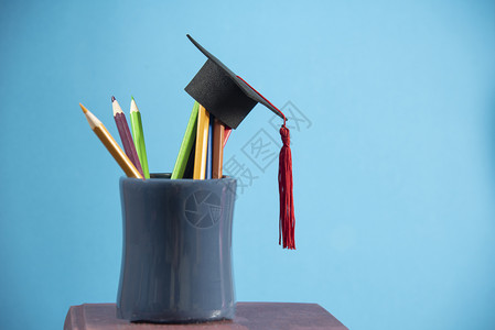 在蓝背景铅笔盒中颜色的毕业上限图片