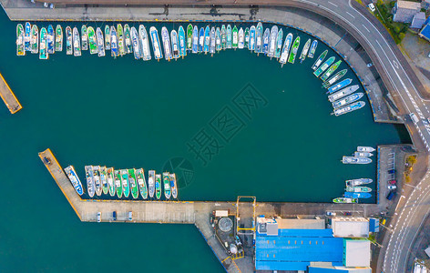 日本城市或镇港湾码头的帆船与蓝色绿宝石海水的空中观景图片