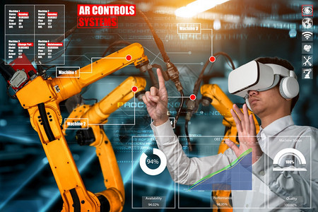 工程师通过扩大现实工业技术应用软件来控制机器人武未来工厂的智能机器人在工业40或第次工业革命的概念下运作图片