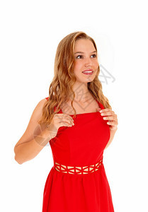 一个非常快乐的美丽年轻女子穿着红色的裙子微笑着与白人背景隔绝图片