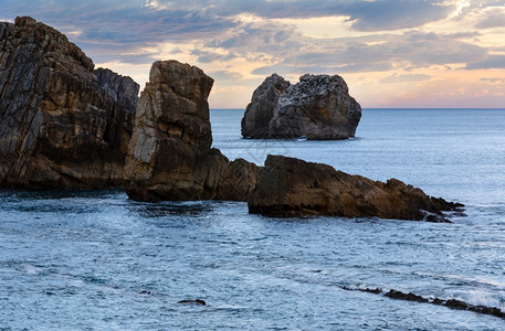 Arnia海滩附近的岩石西班牙大洋日落风景图片
