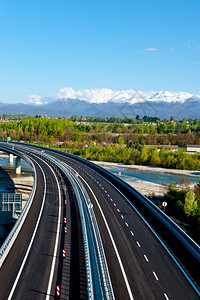 意大利皮埃蒙特雪峰阿尔卑斯山背景的现代高速公路图片