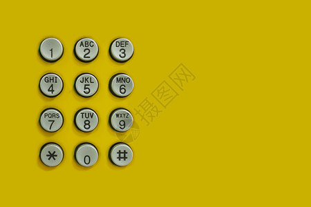 设计技术背景的黄色上电话数字键盘图片