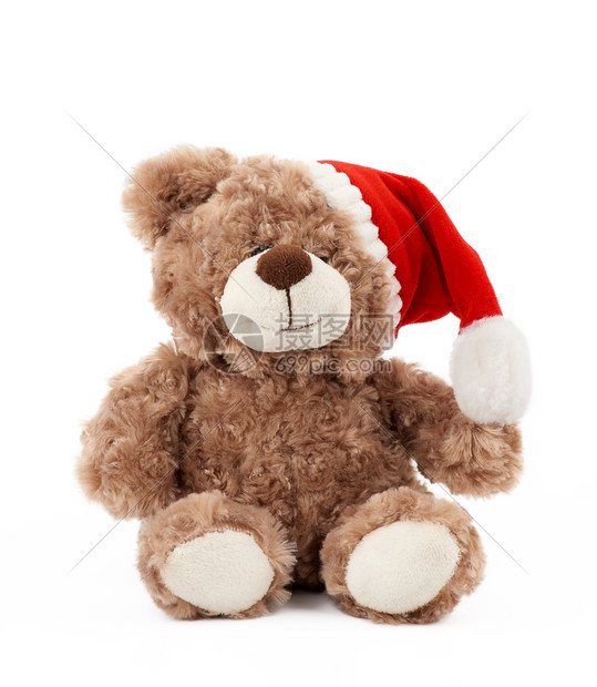 穿着红圣诞帽子的可爱棕色小泰迪熊坐在孤立的白色背景上度假玩具图片
