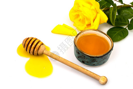 光背景的蜂蜜和黄玫瑰图片