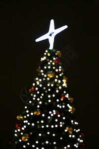 圣诞树在黑暗节日抽象背景中点亮灯光图片