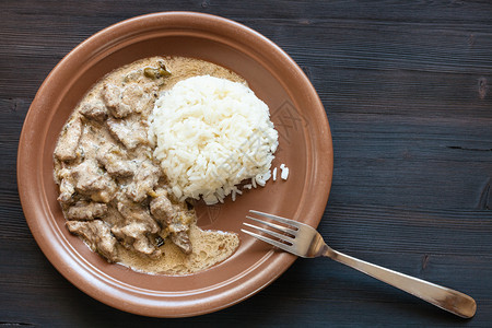 俄罗斯烹饪菜准备吃部分牛肉BeefStroganoffBefStroganovBefstrogananov酸奶油中的炖肉和黑桌棕图片