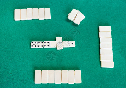 Dominoes棋盘游戏绿色烤桌上有白瓷砖的游戏最上方场视图图片