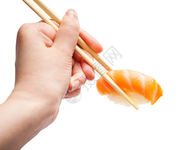 雌手用木筷子握着白底鲑鱼与隔绝图片