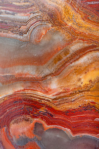 彩色天然带状的CalciteOnyx岩石马氏大理灰岩奥尼克斯的褐色背景彩带状的CalciteOnyx背景图片